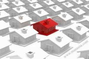 Image of one red home among many white homes