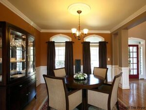 Photo of a formal dining room that's open to the family room and foyer.