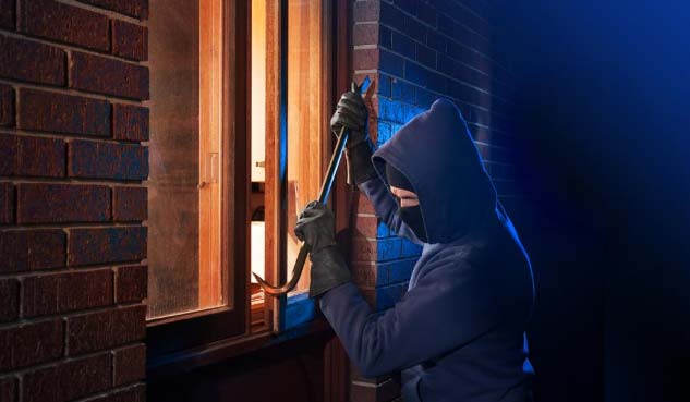 Image of criminal breaking into a home - Ways To Secure your Home