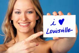 Photo of woman with card that reads I Love Louisville