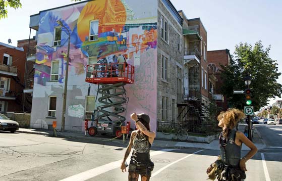 Photo of artists creating murals on a building