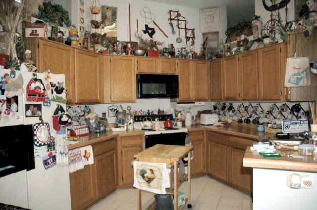 Photo of an extremely cluttered kitchen.