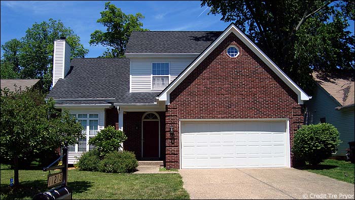 Photo of a home with a standard garage door