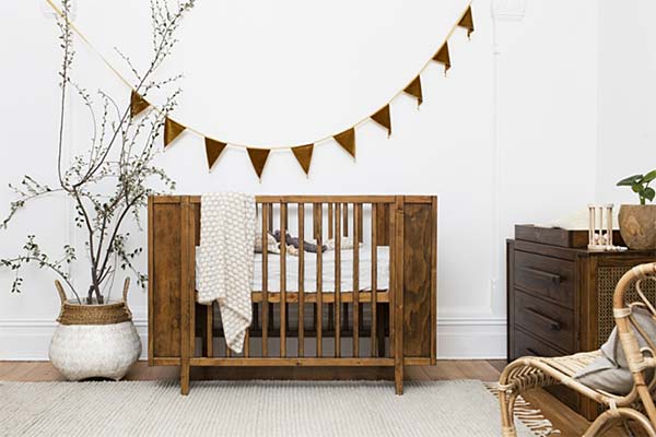 Photo of a fashionable baby's room with crib and baby changing table