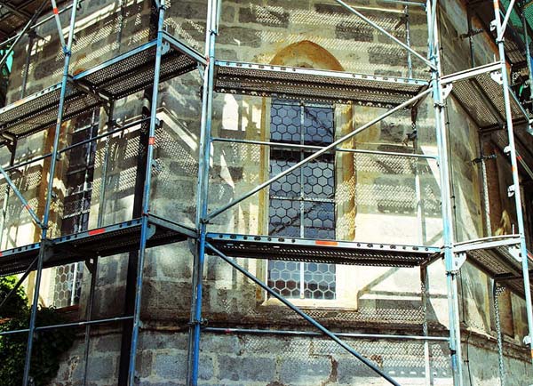 Photo of scaffolding set up for workers to repair old house