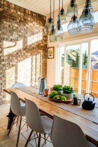 Photo of a dining area with an interior brick wall which is great insulation