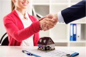 Photo of a real estate agent shaking hands with a home buyer