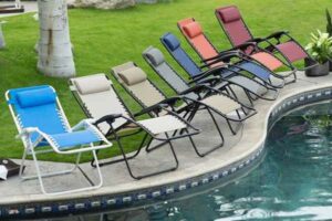 Photo of a pool with lawn chairs