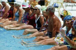 Photo of a group of retirees relaxing in a swimming pool