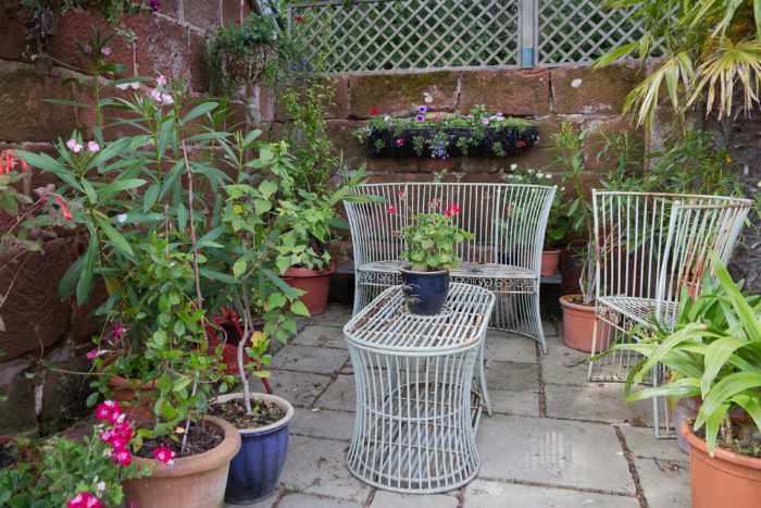 Photo of a seating area in a small courtyard garden
